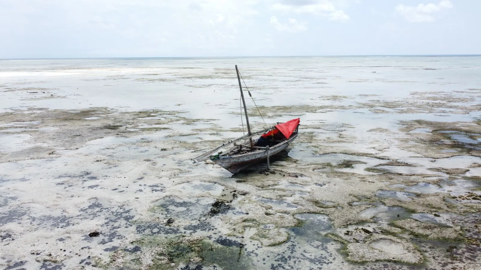Dhow resting on the reef flats at low tide