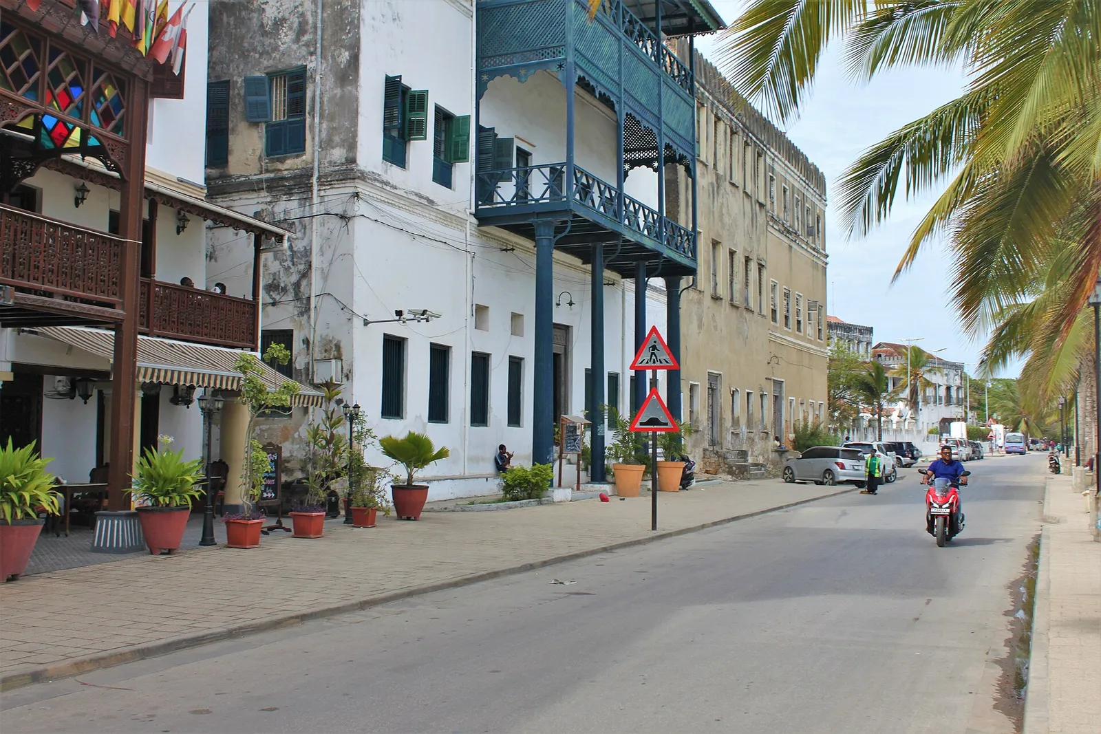 Mizingani Road in Stone Town with carved wooden balconies and palms