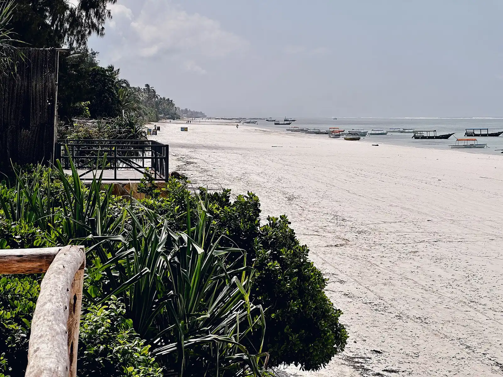 Long white beach at Matemwe with fishing boats moored offshore