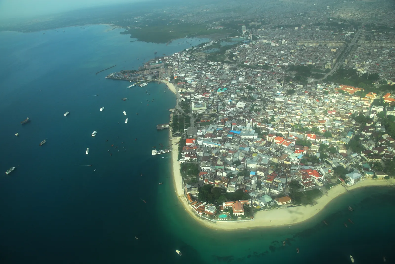 Aerial view of Stone Town on its peninsula, with boats in the harbour