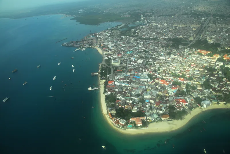 Aerial view of Stone Town on its peninsula, with boats in the harbour