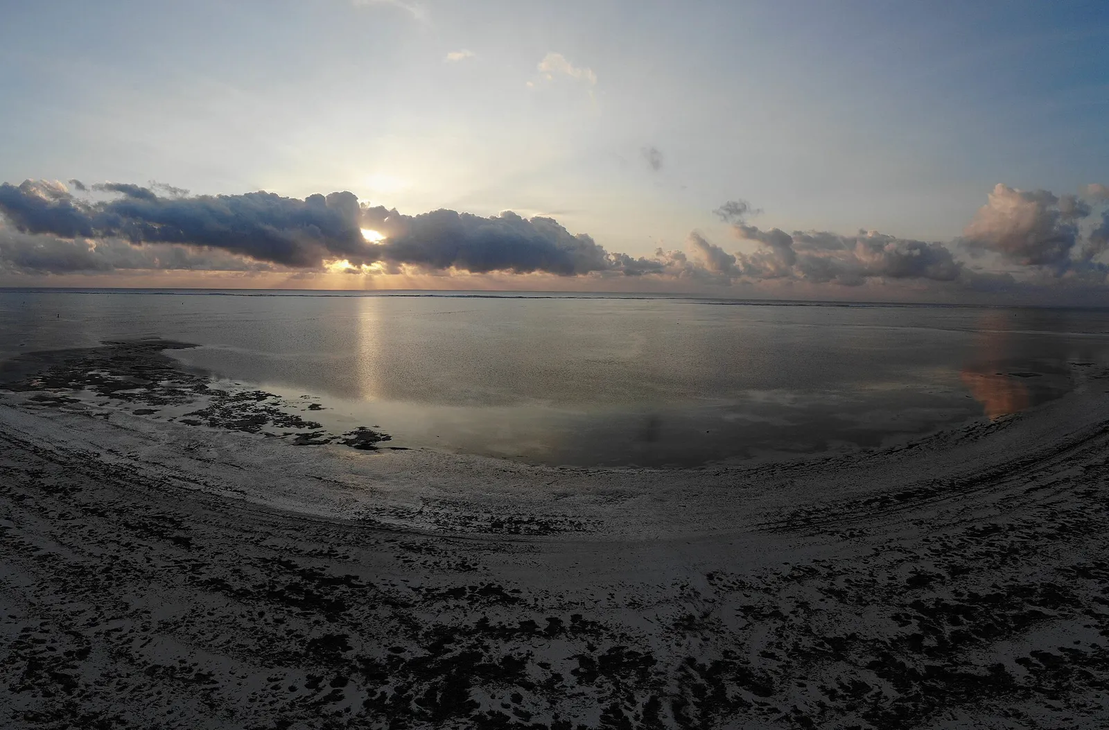 Sunrise over the reef flats at low tide on the east coast of Zanzibar