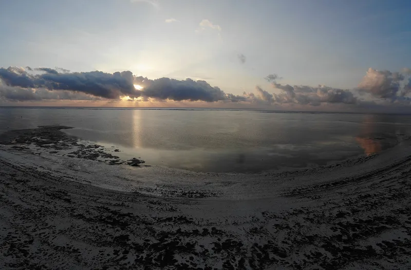Sunrise over the reef flats at low tide on the east coast of Zanzibar